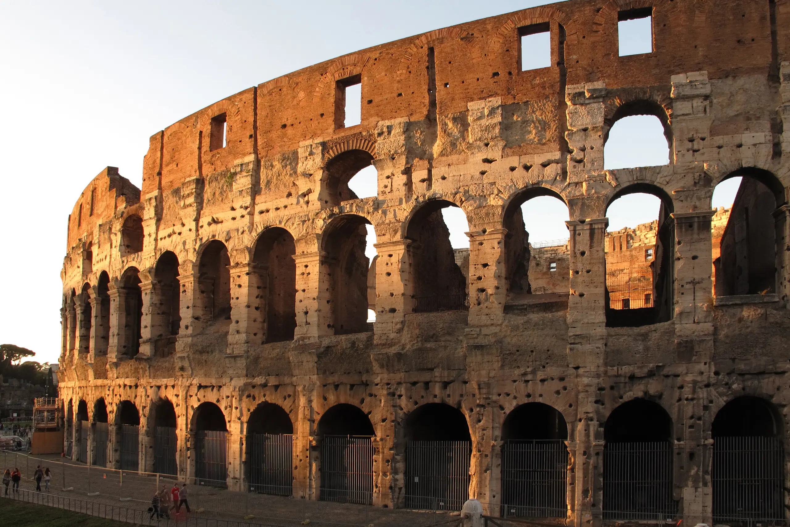 The Colosseum's weathered arches glowing in low, warm light.